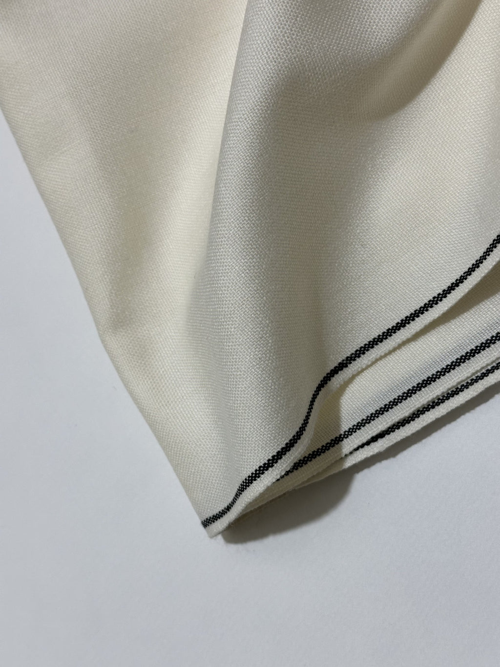Off White Handmade Hamtaa wool fabric, black selvedge border detail